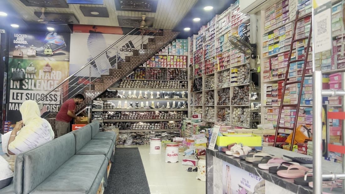 Walking along the aisles between walls of stacked shoeboxes