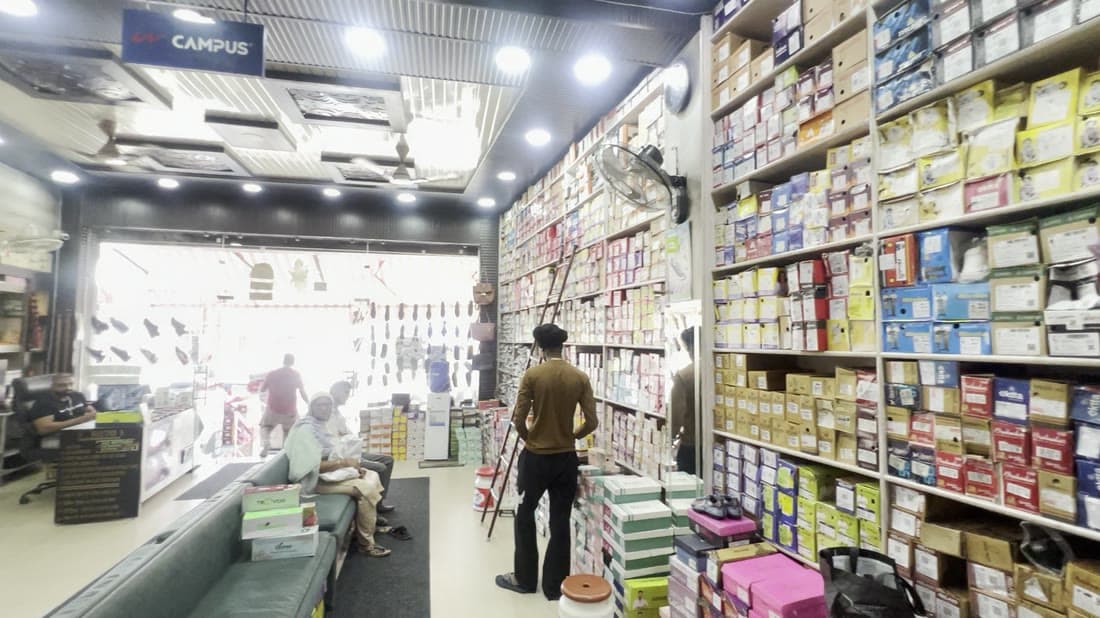 Looking down a long aisle towards the bright shopfront